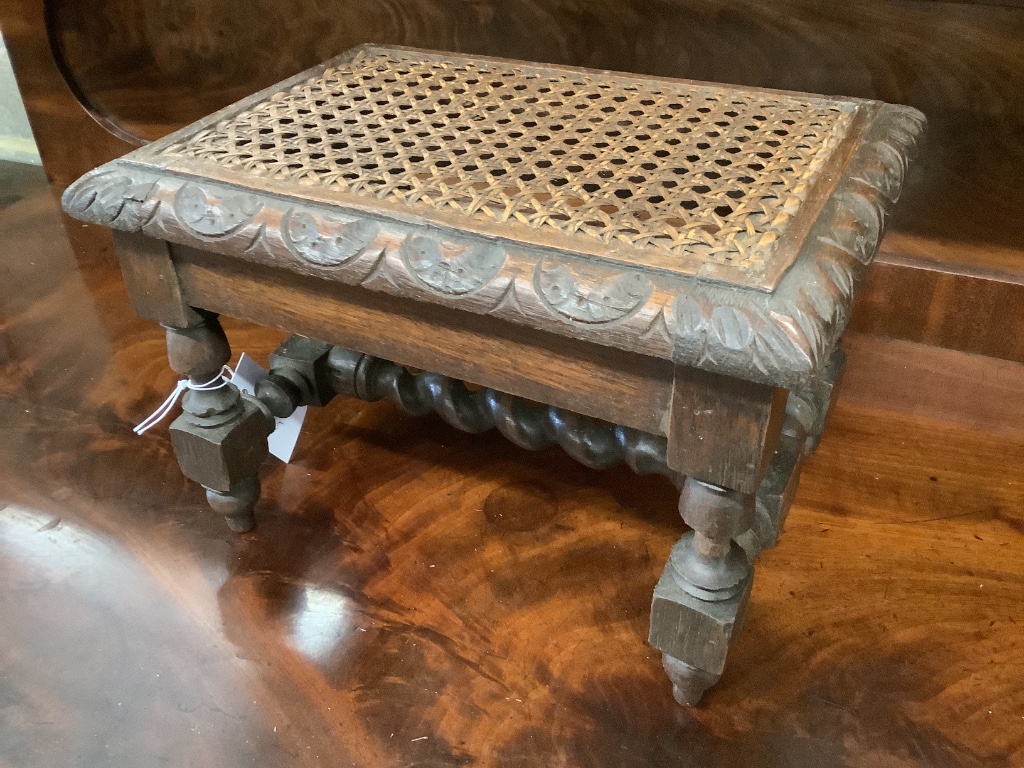 An early 20th century carved oak stool, width 29cm